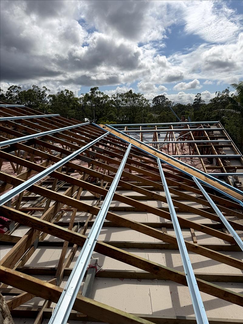 Old roof stripped and new steel roof battens fixed to the timber trusses