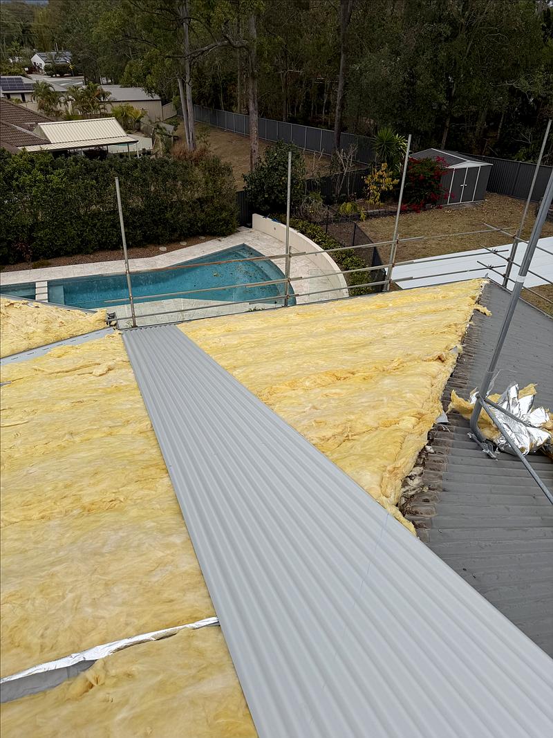 New Colorbond corrugated sheets being fixed over the roof blanket
